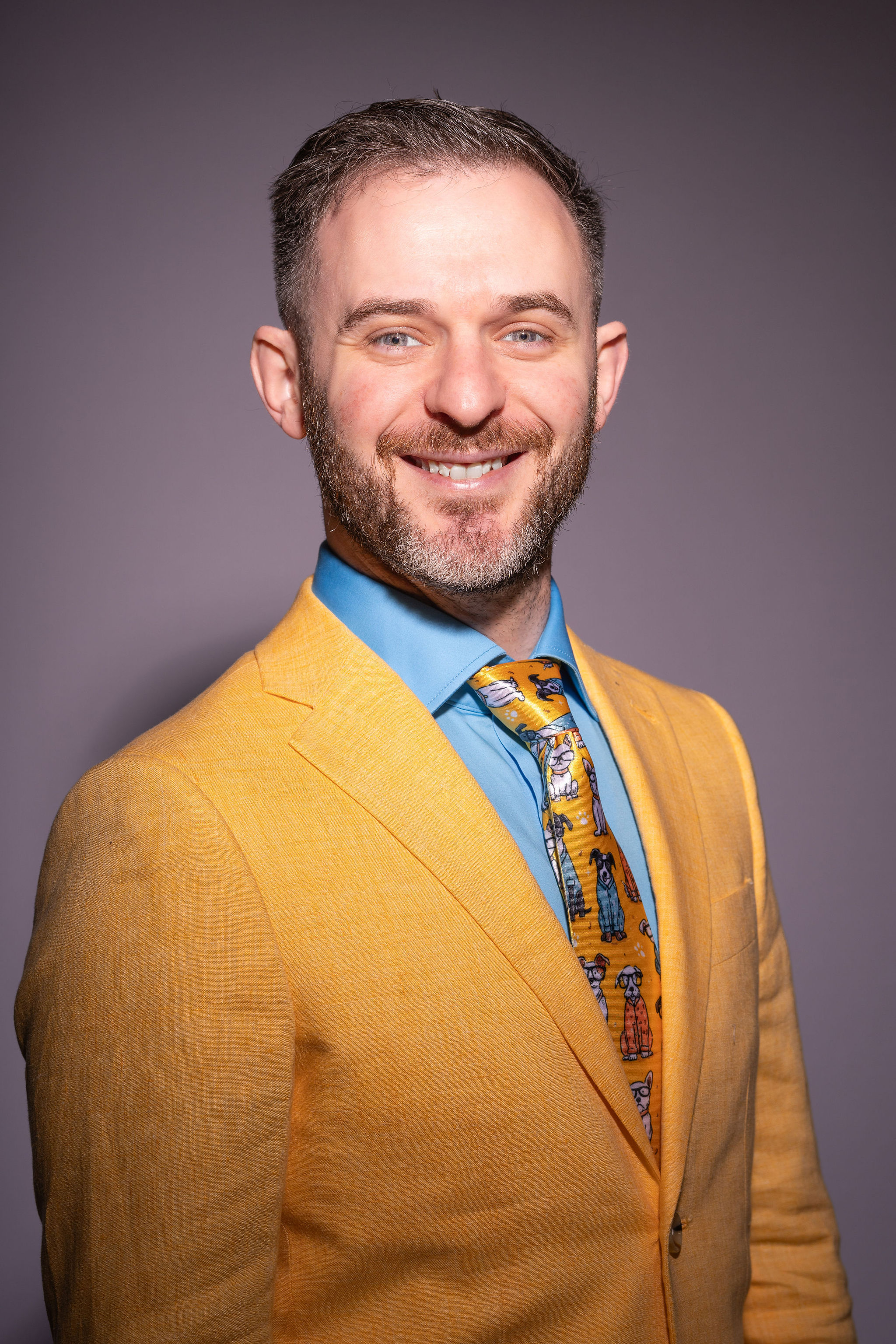 Dr. Stacey Podkovik in a yellow suit and pediatric tie.
