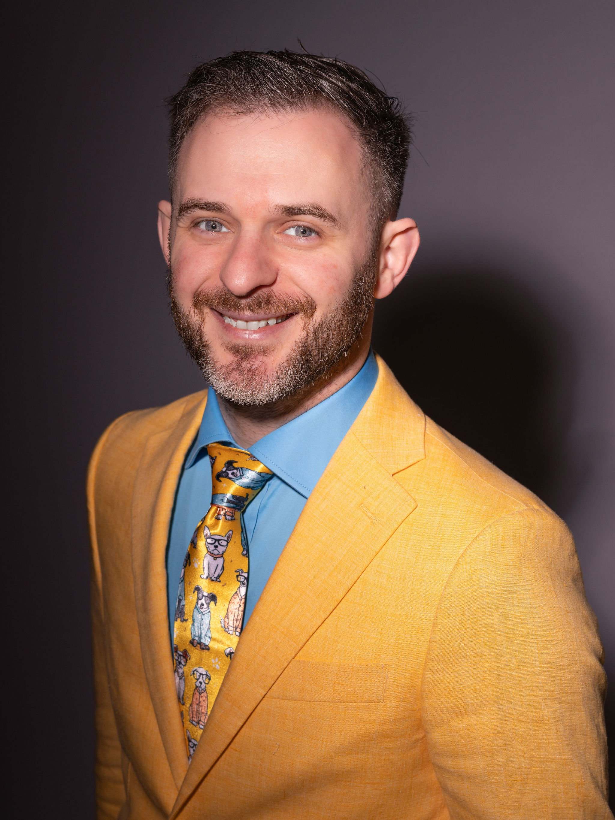Dr. Stacey in his yellow suit and blue shirt.