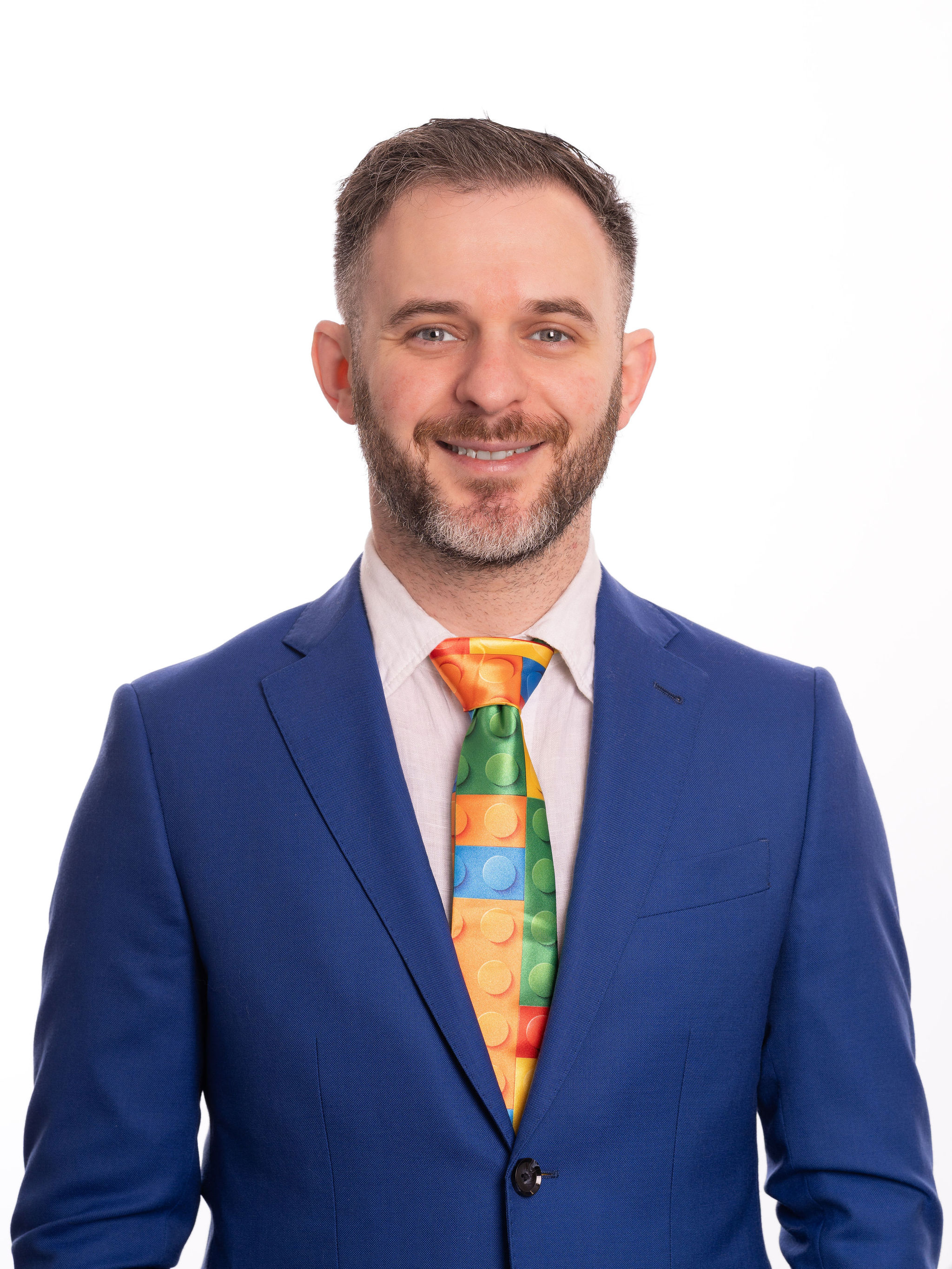 Dr. Stacey Podkovik in a blue suit and colorful pediatric tie.